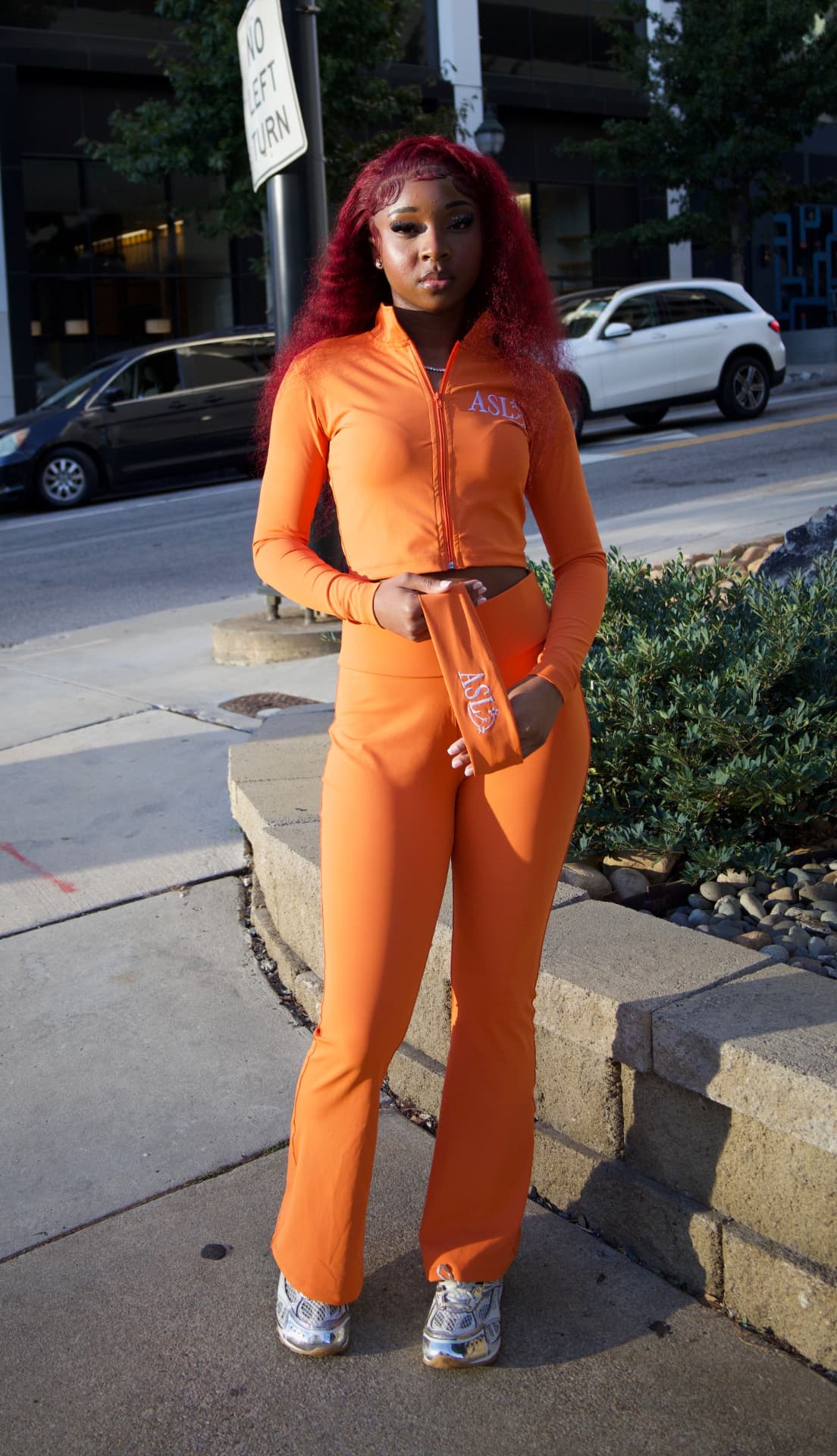 Full-length ASL orange zip-up and flared pants