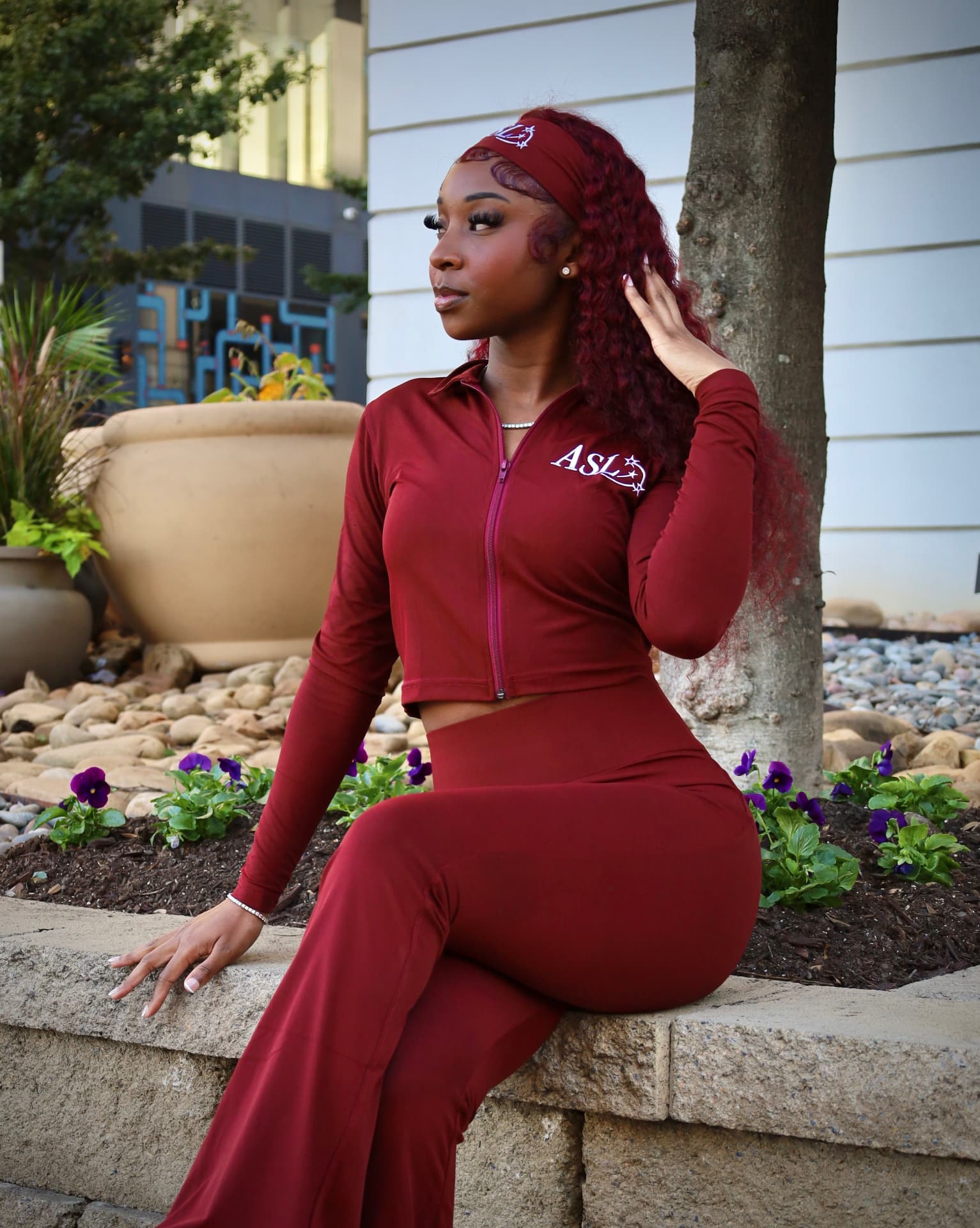 Seated model wearing the ASL burgundy matching set